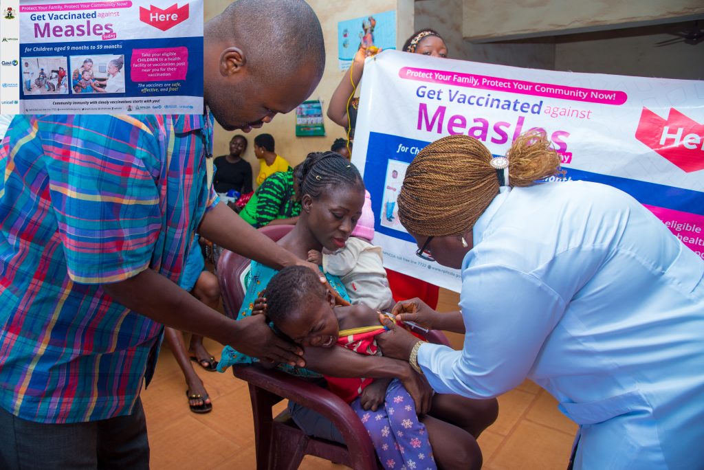 Baby gets first shot of Measles vaccination.